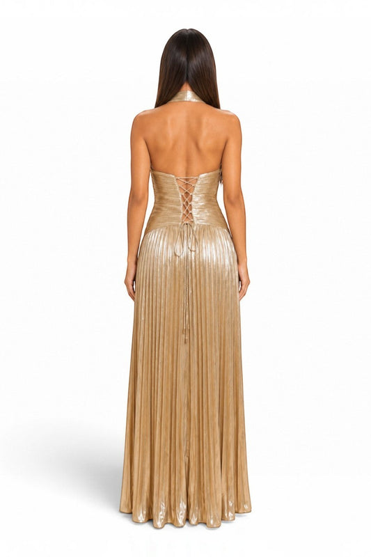 Back view of a Pink shop by maf metallic gold pleated halter maxi dress with a lace-up corset back detail.