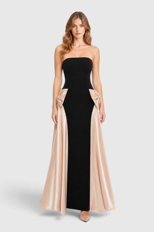 Pink shop by maf black strapless evening gown with champagne satin side bows and draped overskirt on a model