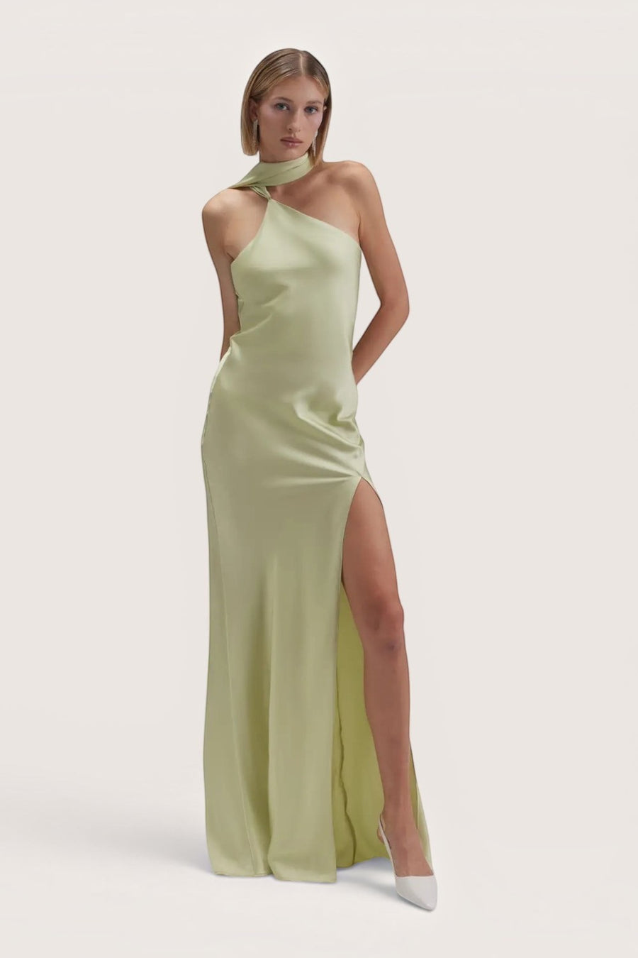Model wearing a Pink shop by maf sage green satin maxi dress with an asymmetrical halter neckline and side slit