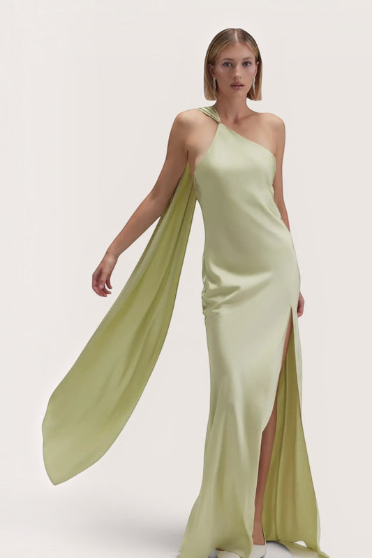 Model wearing a Pink shop by maf sage green satin maxi dress with an asymmetrical halter neckline and long scarf.