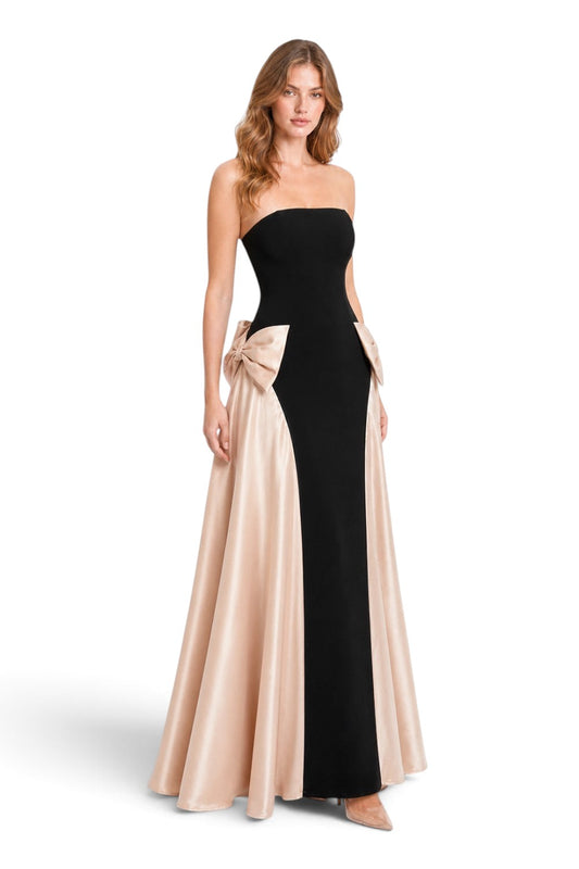 Pink shop by maf strapless black evening gown with champagne satin side bows and flowing overskirt on a model
