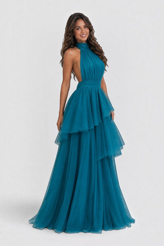 Pink shop by maf teal tulle halter neck gown with a tiered peplum waist and full skirt worn by a smiling model.
