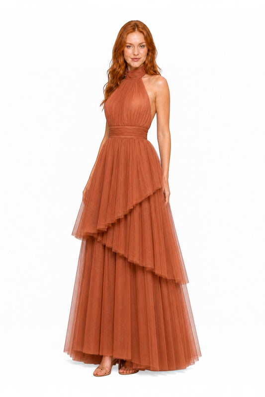 Pink shop by maf terracotta tulle halter gown with tiered skirt and bow neck detail worn by a model