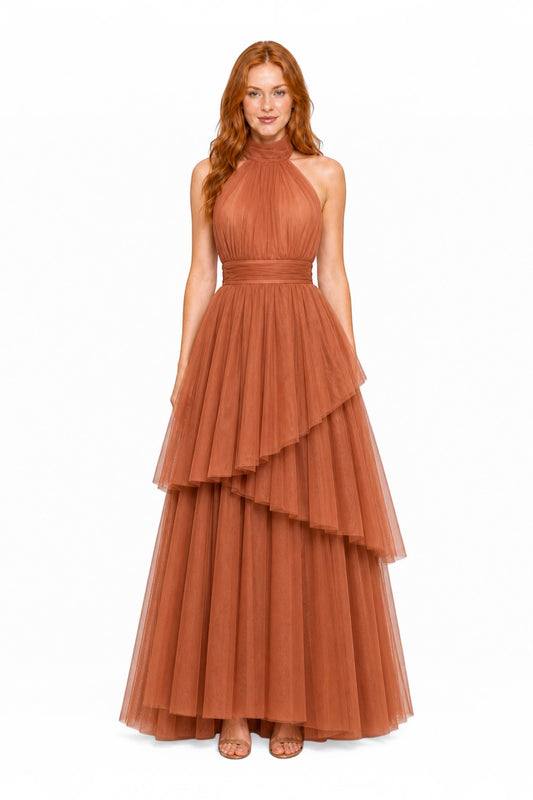 Pink shop by maf terracotta tulle halter gown with tiered skirt layers and a bow neck detail on a model