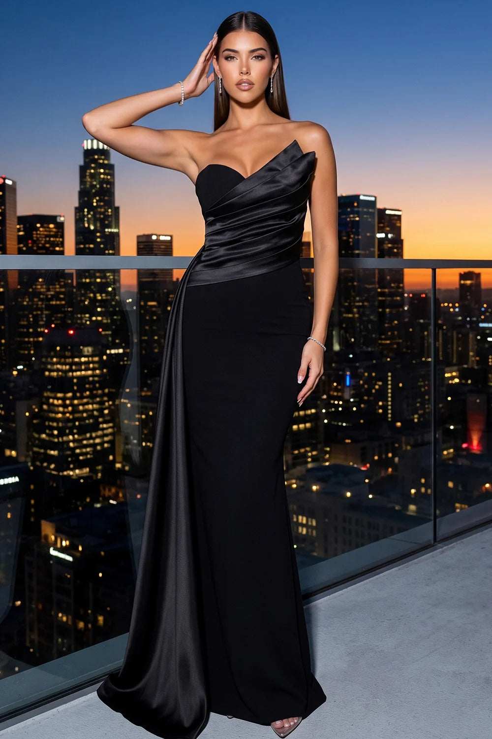 Model wearing the Pink shop by maf black satin mermaid gown with side sash at a rooftop at dusk