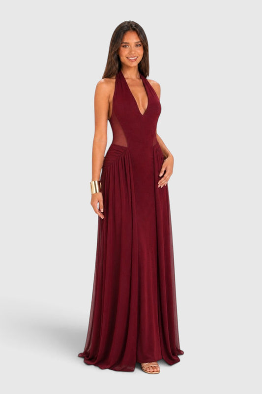 Pink shop by maf wine red maxi dress with halter neckline, mesh side panels, and flowing skirt on a smiling model