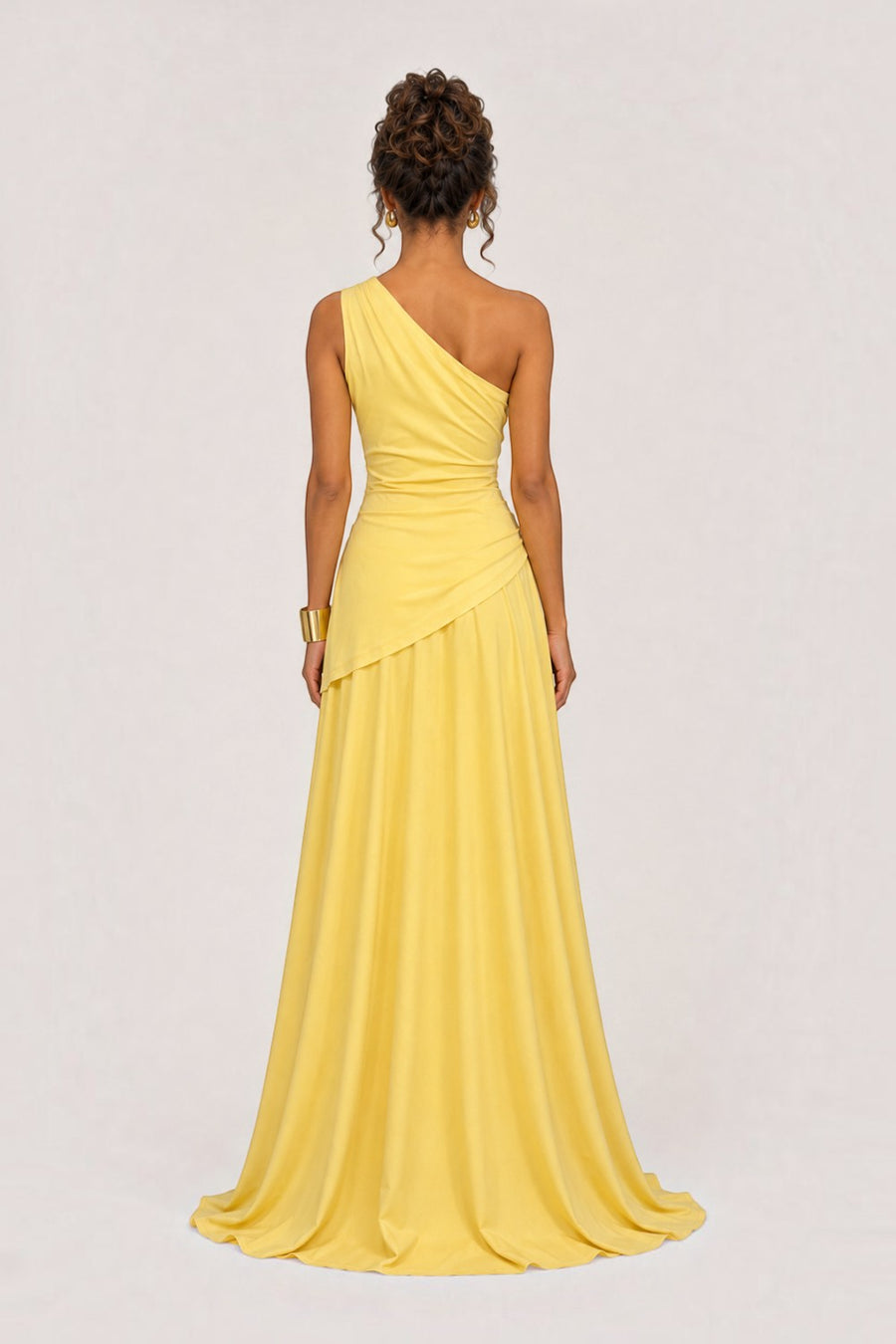 Back view of a Pink shop by maf yellow one-shoulder floor-length gown with draped waist and flowing skirt