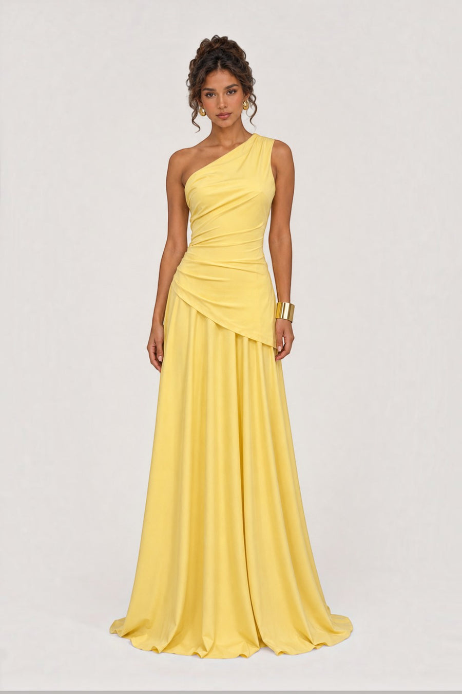 Model wearing a yellow Pink shop by maf one-shoulder floor-length gown with side draping and a fluid skirt.